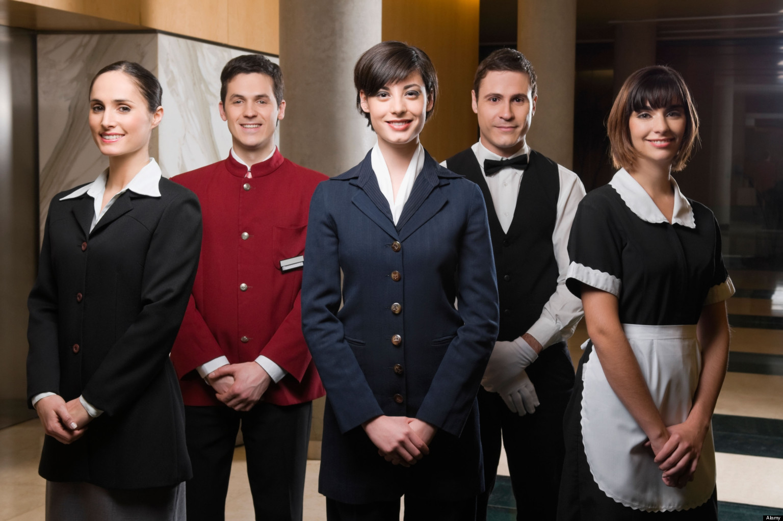 B62PW9 Hotel staff standing together and smiling